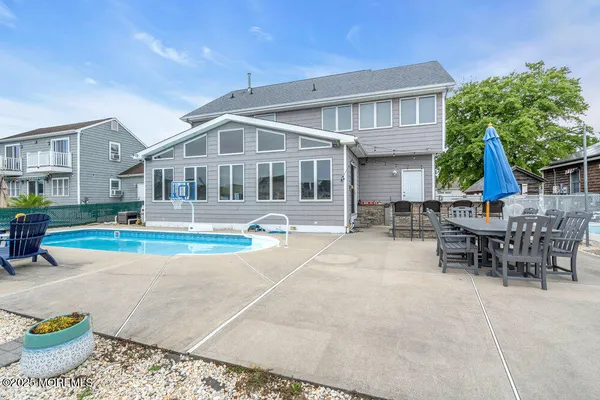 a view of a house with backyard and sitting area