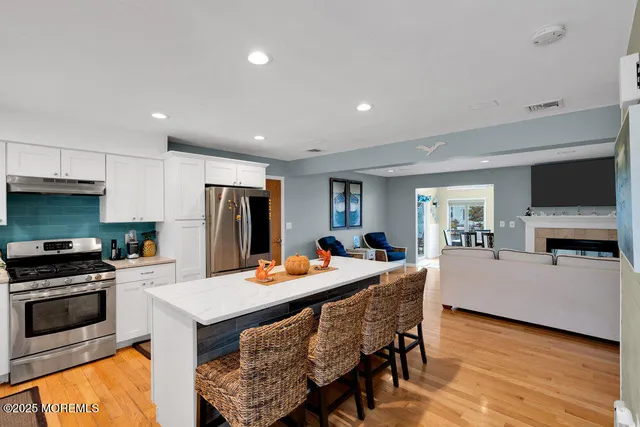 a large kitchen with a table and chairs in it