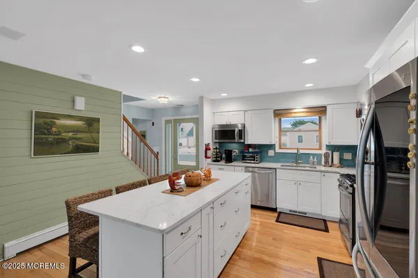 a kitchen with a sink stove and refrigerator