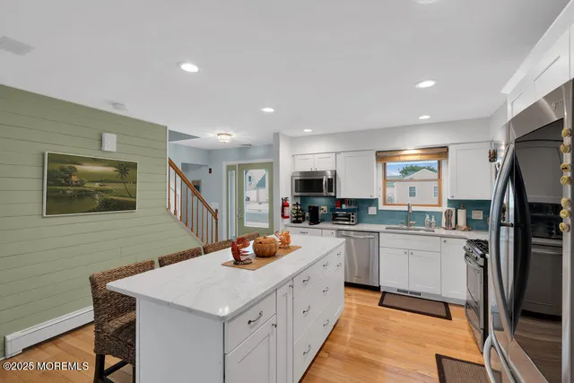 a kitchen with a sink stove and refrigerator