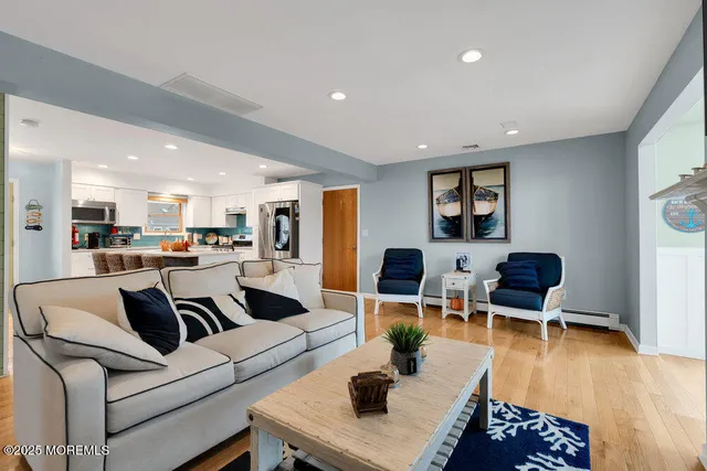 a living room with furniture and kitchen view