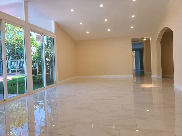 a view of an empty room with glass door
