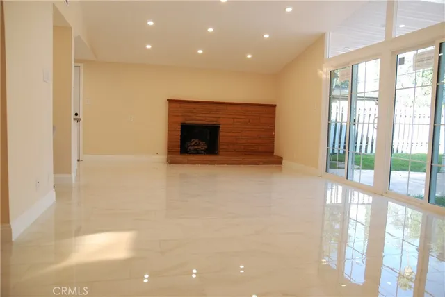 a view of an empty room with a fireplace