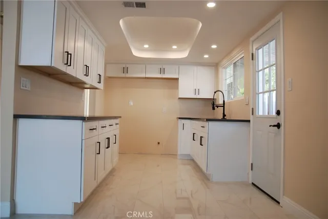 a kitchen with cabinets and window