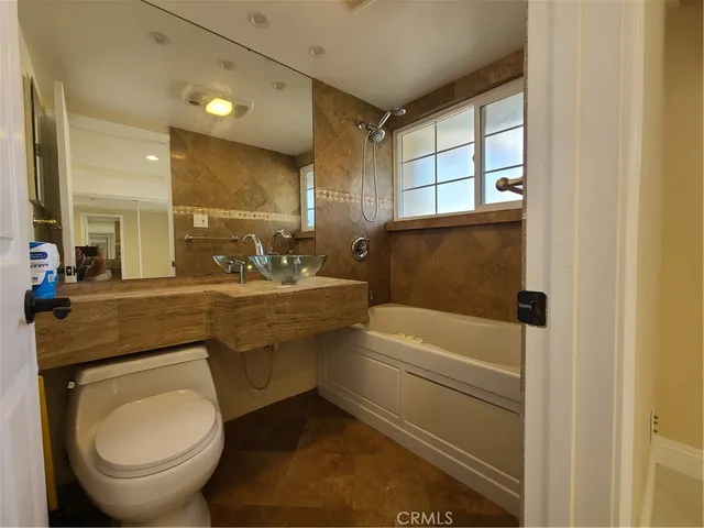 a bathroom with a sink a toilet and bathtub