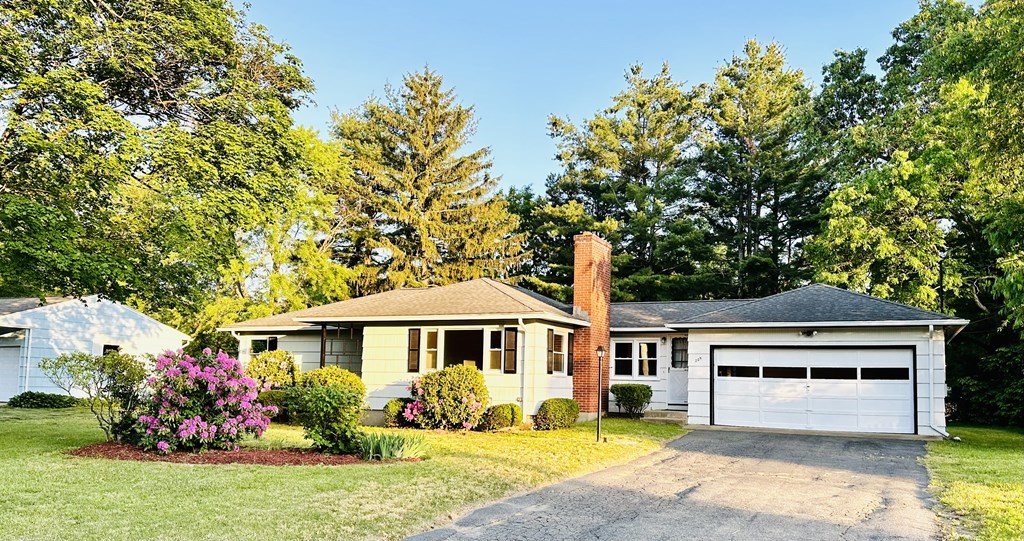 209 Birch Road Longmeadow, MA 01106 - Photo 1 of 13 a front view of a house with a yard table and chairs