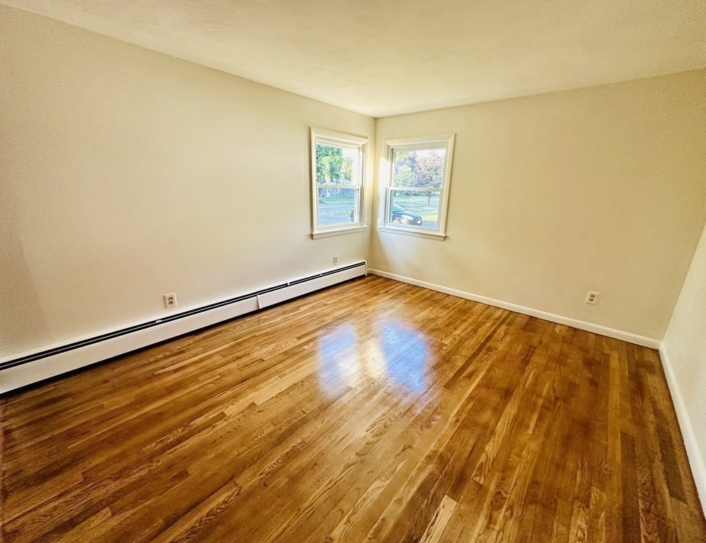 209 Birch Road Longmeadow, MA 01106 - Photo 4 of 13 a view of an empty room with wooden floor and a window