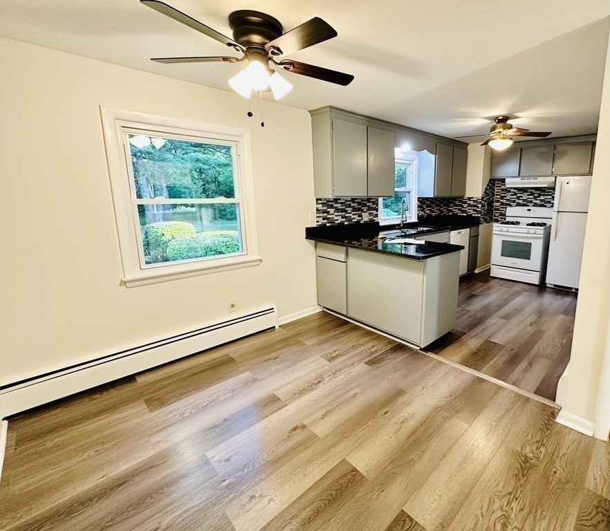 209 Birch Road Longmeadow, MA 01106 - Photo 5 of 13 a kitchen with stainless steel appliances kitchen island granite countertop a stove a sink and a refrigerator