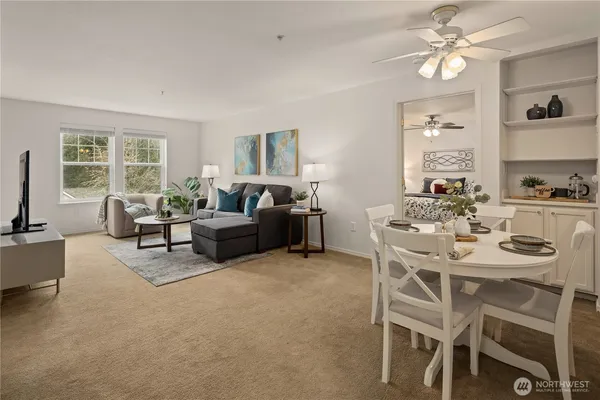 a living room with furniture a chandelier and a window