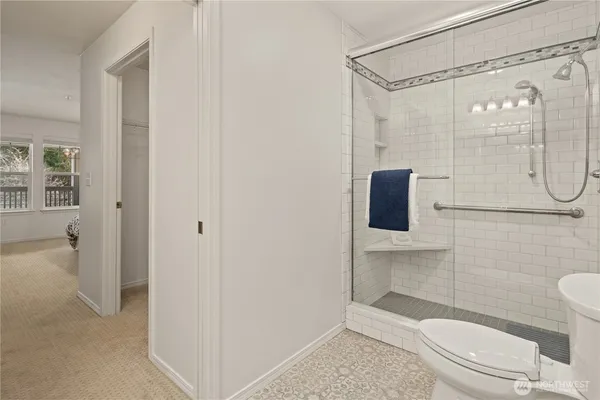 a bathroom with a shower a toilet and sink