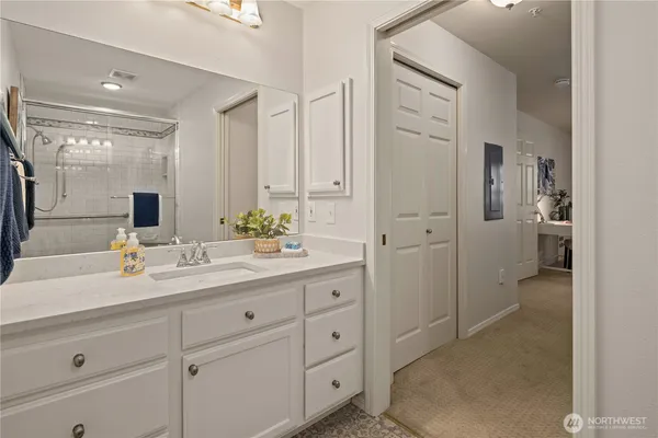 a spacious bathroom with a granite countertop sink mirror and shower