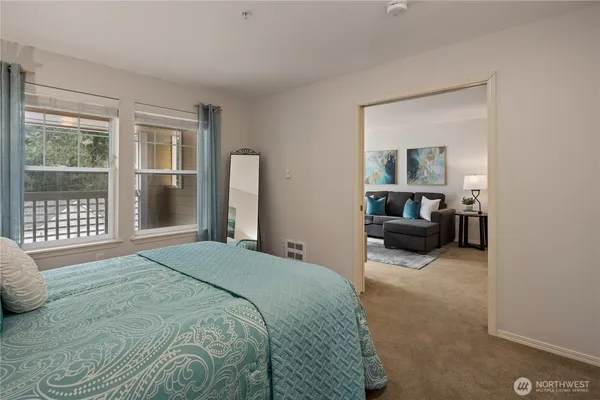 a bedroom with a bed couch and a window