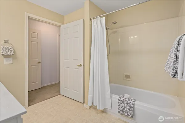 a bathroom with a shower and a glass door