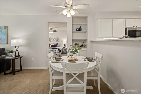 a view of a dining room with furniture and chandelier