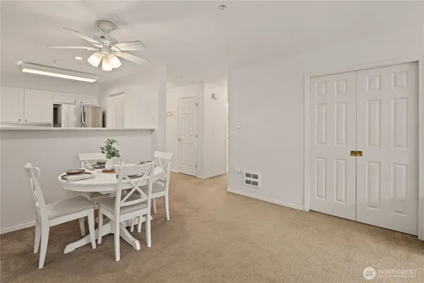 a view of a dining room with furniture and a chandelier fan