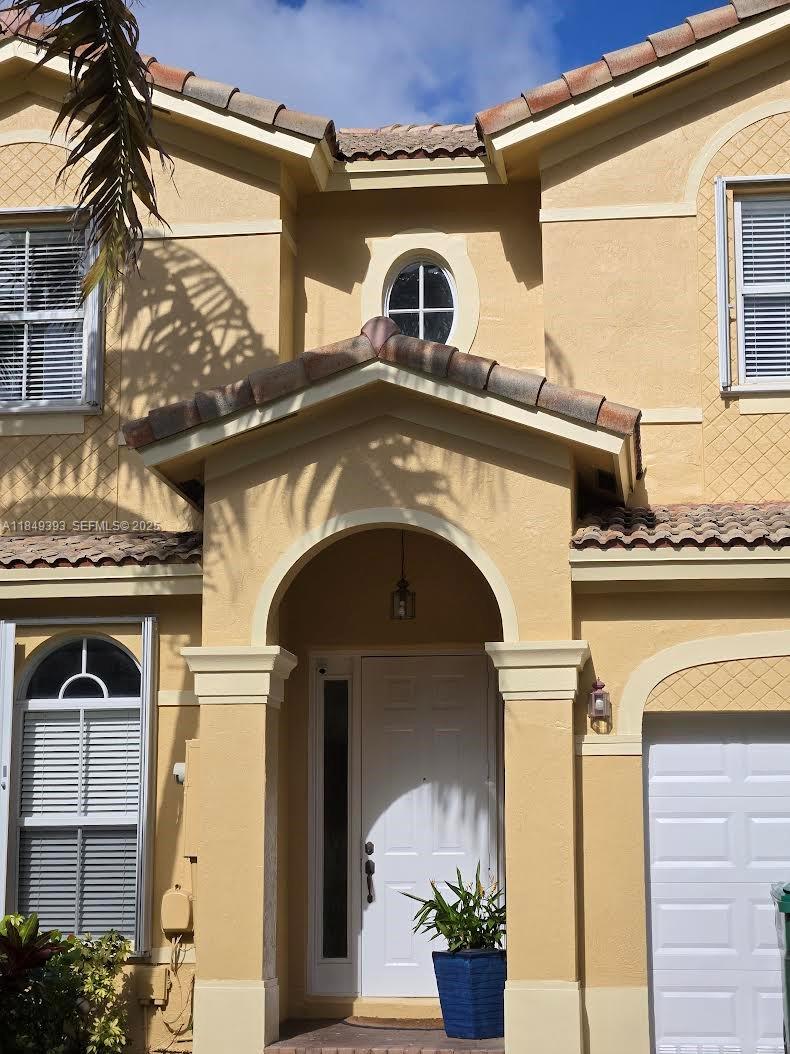 11575 Southwest 138th Avenue Miami, FL 33186 - Photo 1 of 23 a front view of a house with a balcony