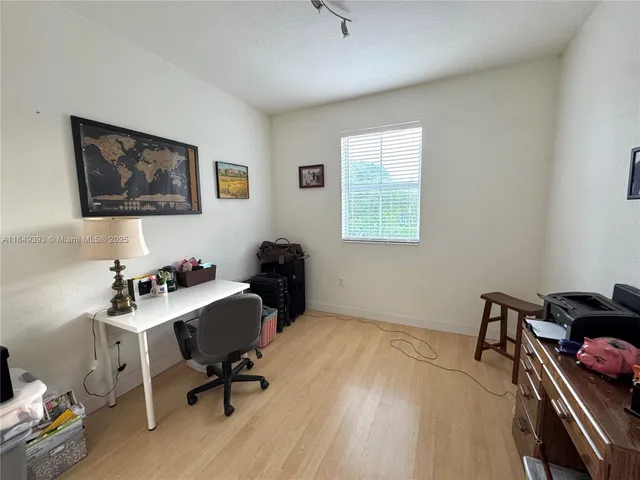 a livingroom with workspace and a couch