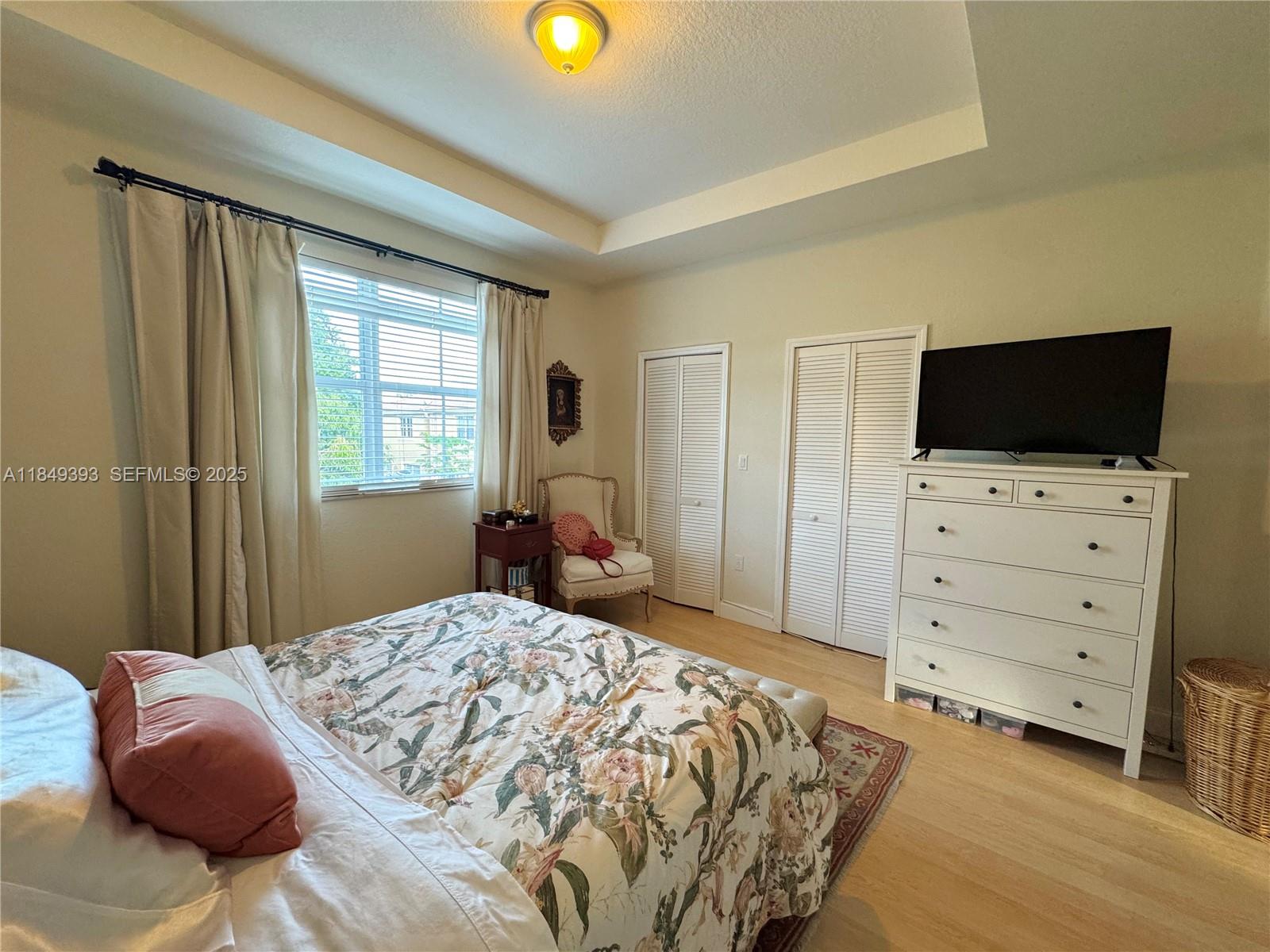 11575 Southwest 138th Avenue Miami, FL 33186 - Photo 14 of 23 a bedroom with a bed and a flat screen tv