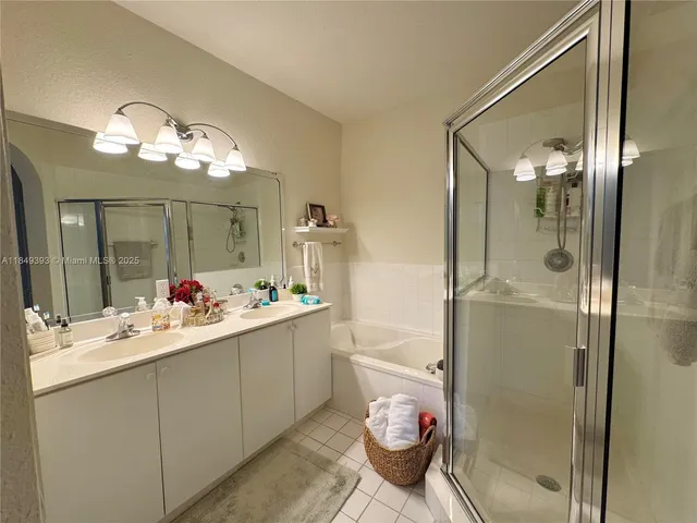 a kitchen that has a lot of cabinets and wooden floor