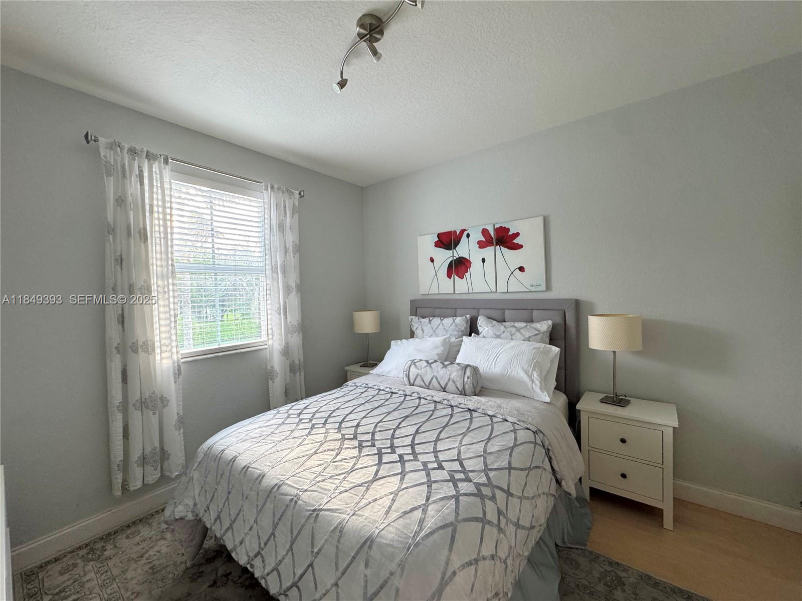 11575 Southwest 138th Avenue Miami, FL 33186 - Photo 17 of 23 a bedroom with a bed and a window