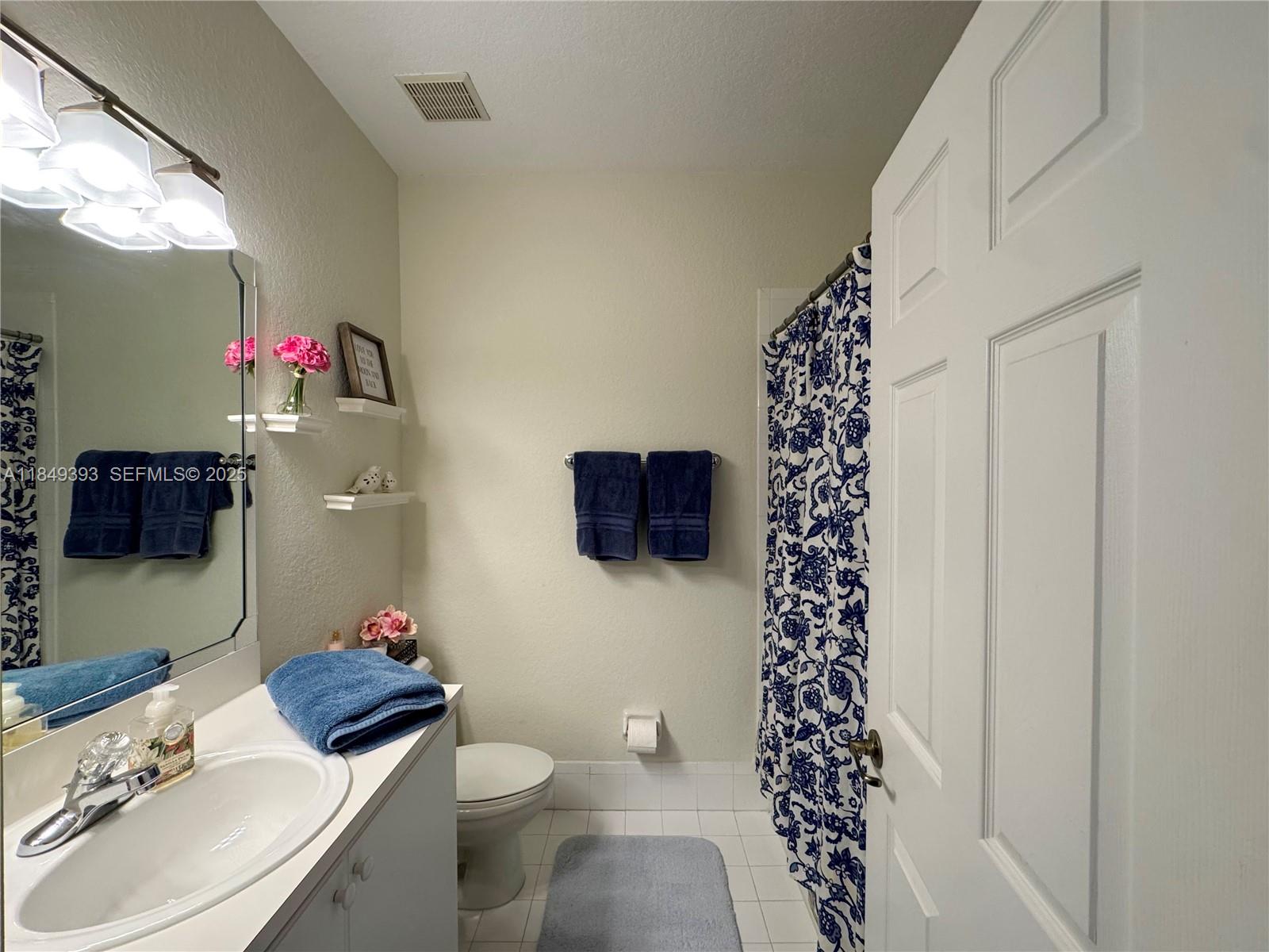 11575 Southwest 138th Avenue Miami, FL 33186 - Photo 19 of 23 a bathroom with a sink toilet and a mirror