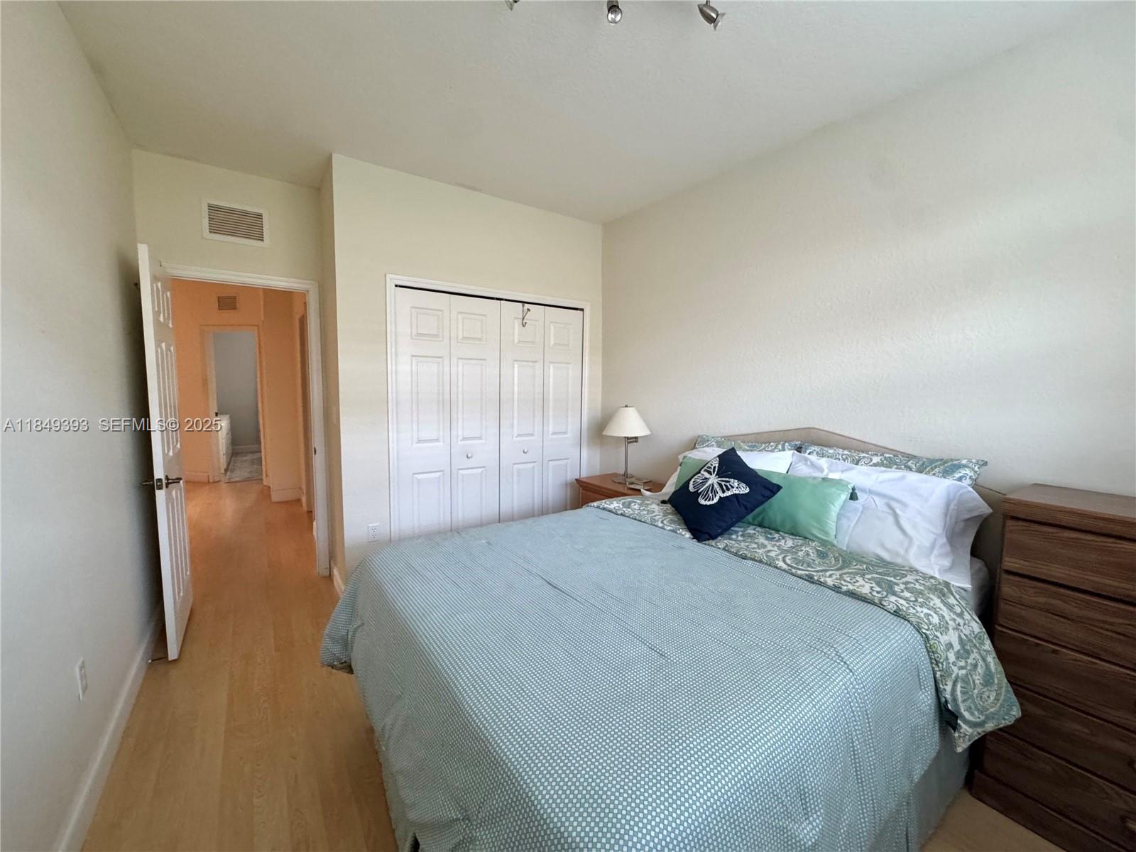 11575 Southwest 138th Avenue Miami, FL 33186 - Photo 20 of 23 a bedroom with a bed and wooden floor