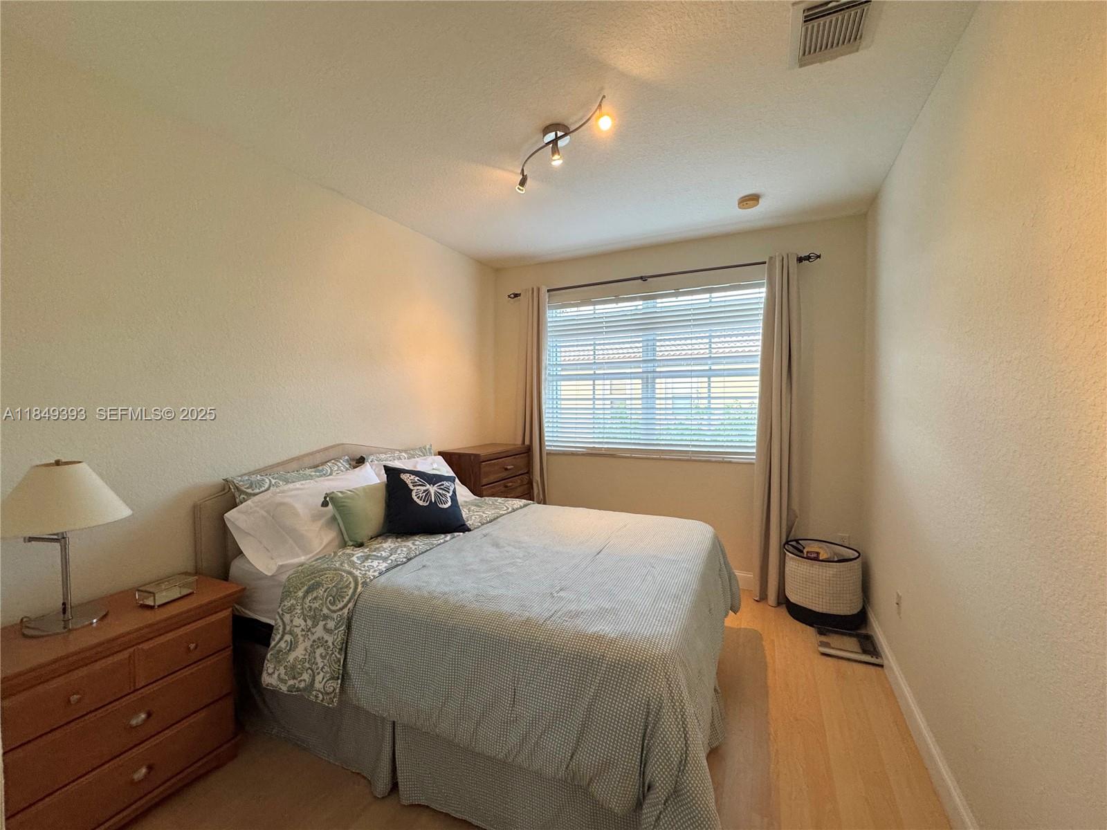 11575 Southwest 138th Avenue Miami, FL 33186 - Photo 21 of 23 a bedroom with a bed and a window