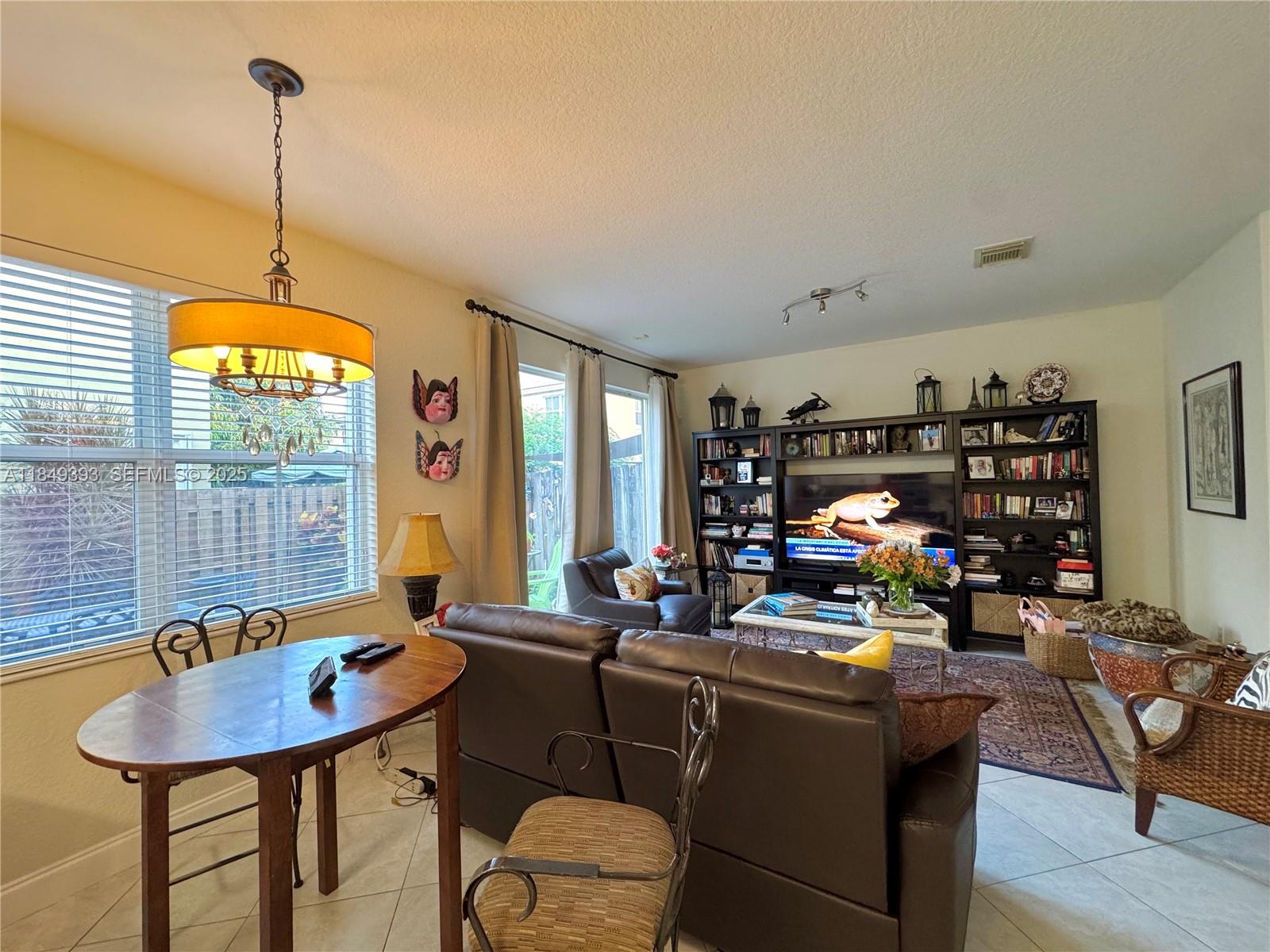 11575 Southwest 138th Avenue Miami, FL 33186 - Photo 7 of 23 a living room with furniture and a table