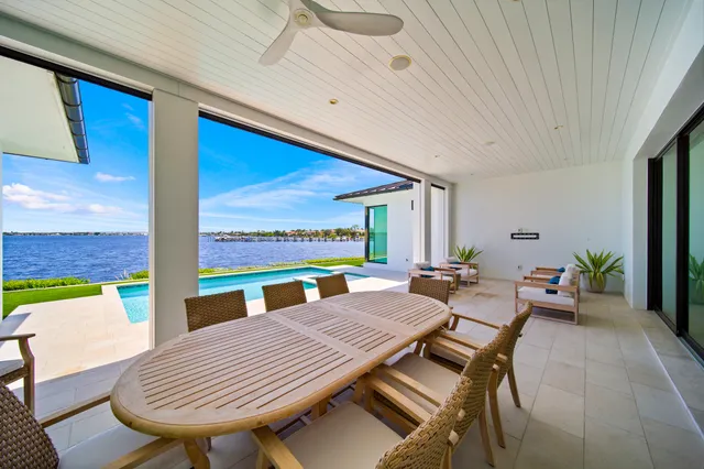 a very nice looking living room with a large window and chandelier