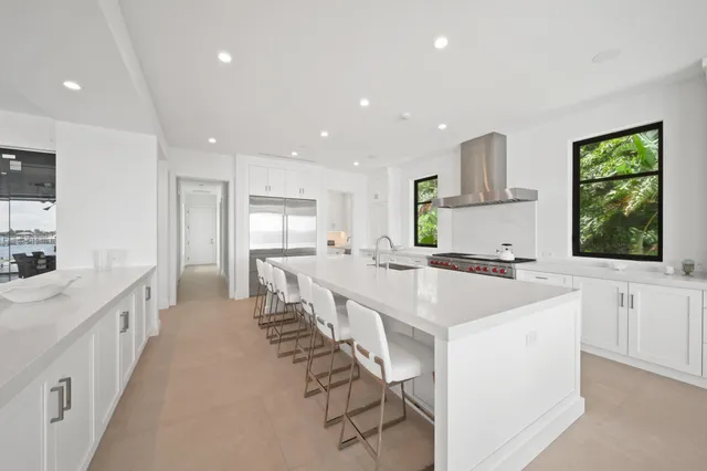 a dining room with furniture and a floor to ceiling window