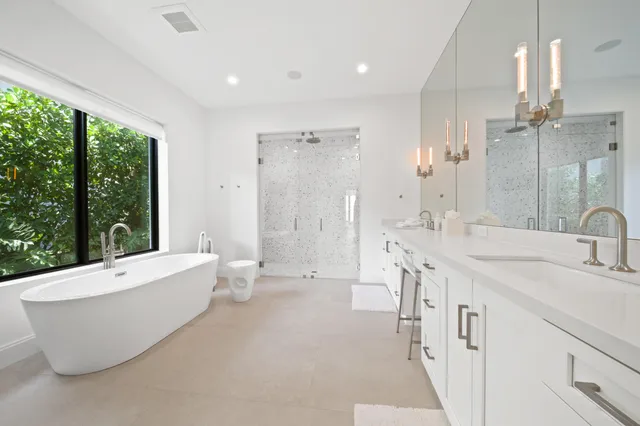 a large bedroom with a bed and large window