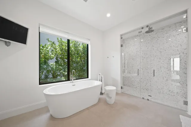 a large white bed in a white room