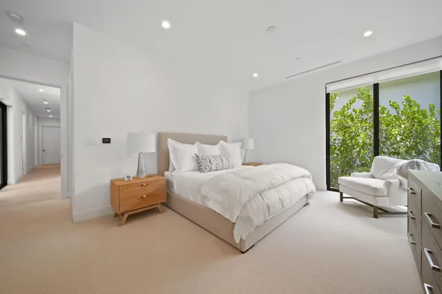 a bathroom with double vanity and a mirror