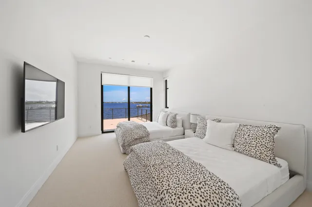 a view of a patio with a table and chairs under an umbrella