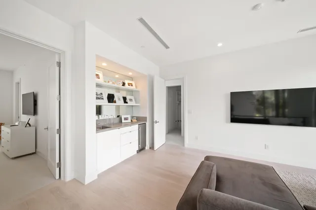 a aerial view of a house with a garden and lake view