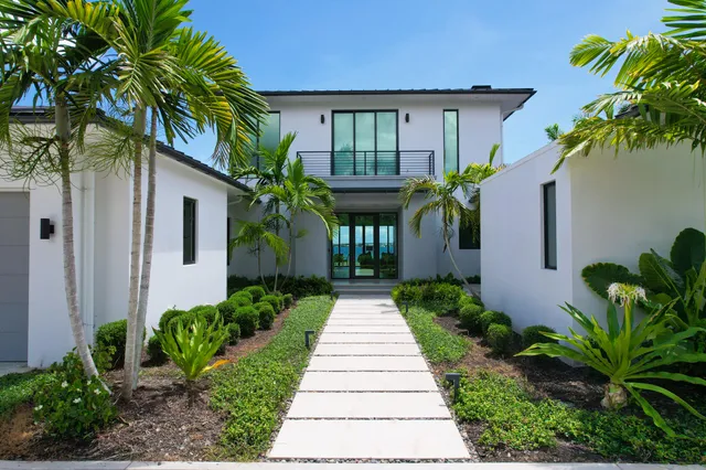 a front view of house with a garden