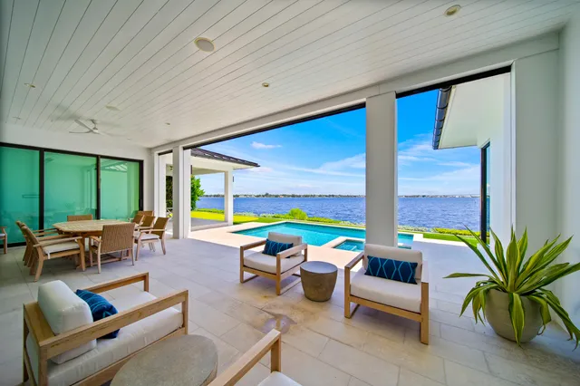 a view of a house with a swimming pool and a yard