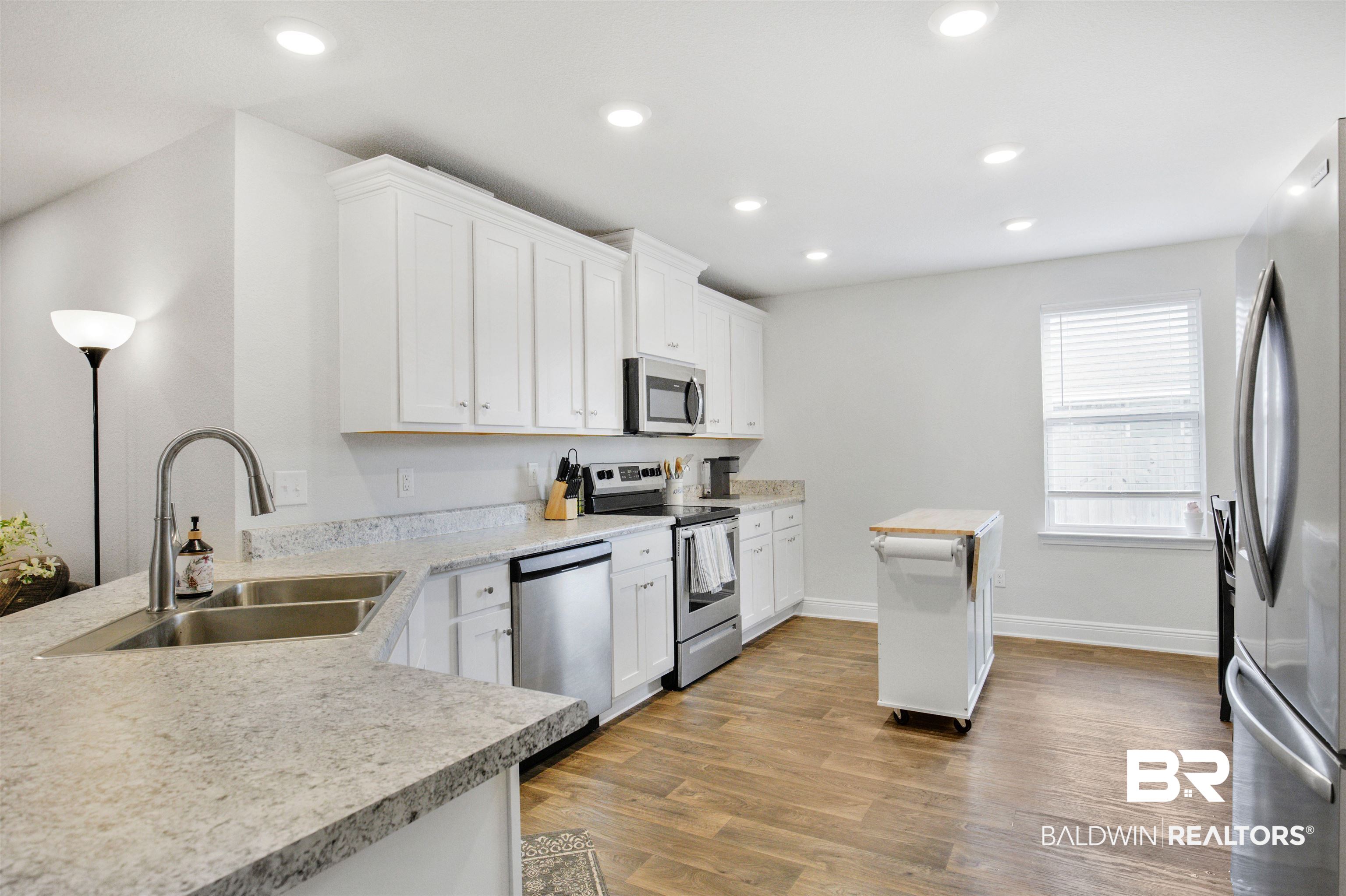 1970 Redpine Drive Semmes, AL 36575 - Photo 2 of 25 Kitchen with recessed lighting, light countertops, appliances with stainless steel finishes, light wood-style floors, and a sink