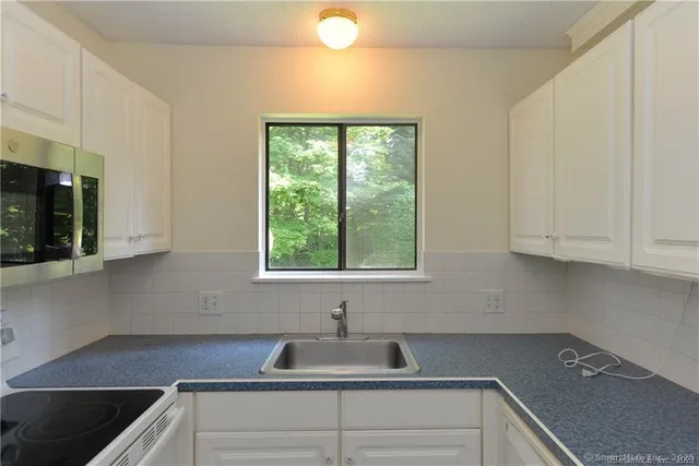 a kitchen with a sink and cabinets