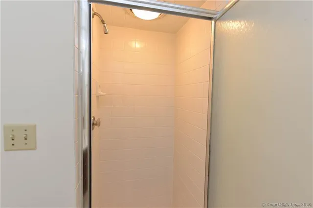 a bathroom with a glass shower door