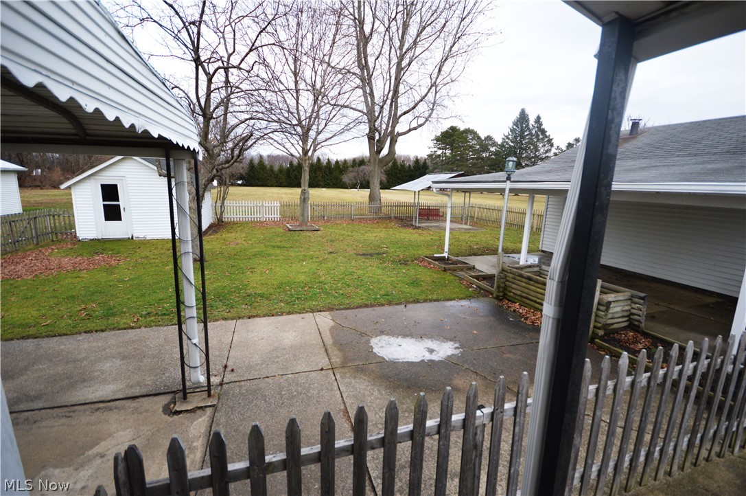 800 Park Road Painesville, OH 44077 - Photo 25 of 28 Fenced area of the huge Backyard has lots of Patio space, yard for kids & pets plus an Outbuilding .