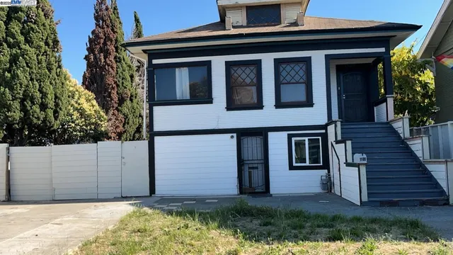 a house that has a tree in front of the house