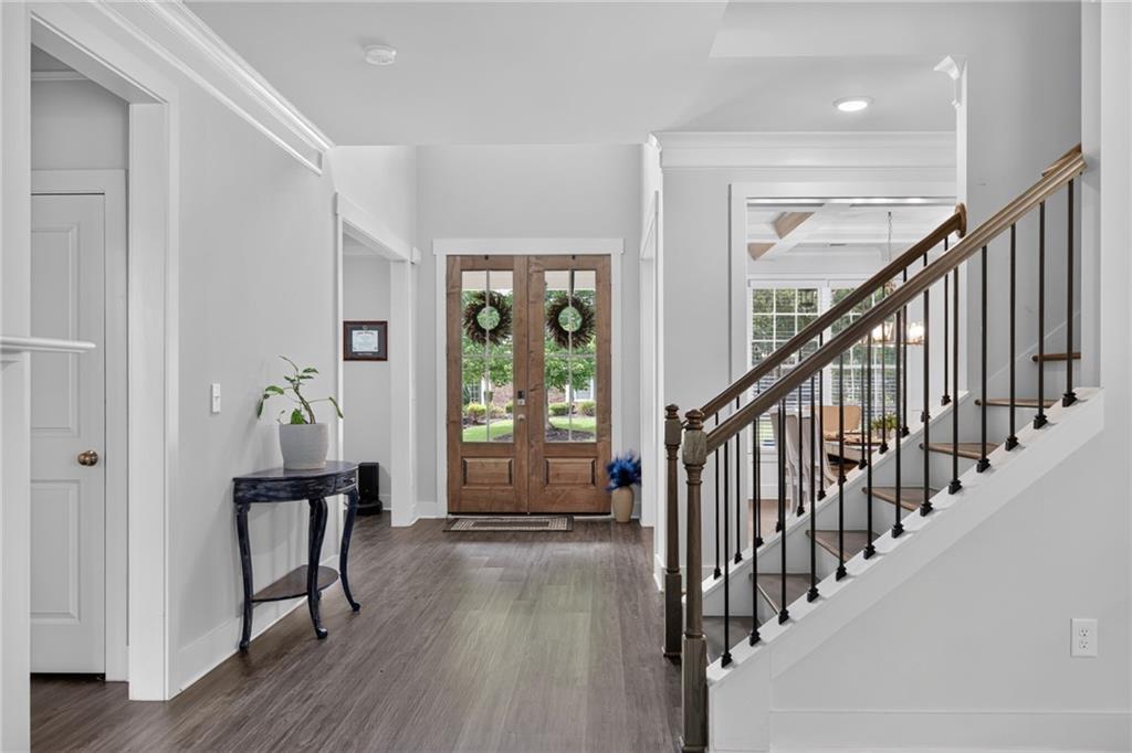 139 Manchester Lane Villa Rica, GA 30180 - Photo 6 of 60 a view of a hallway with wooden floor and stairs