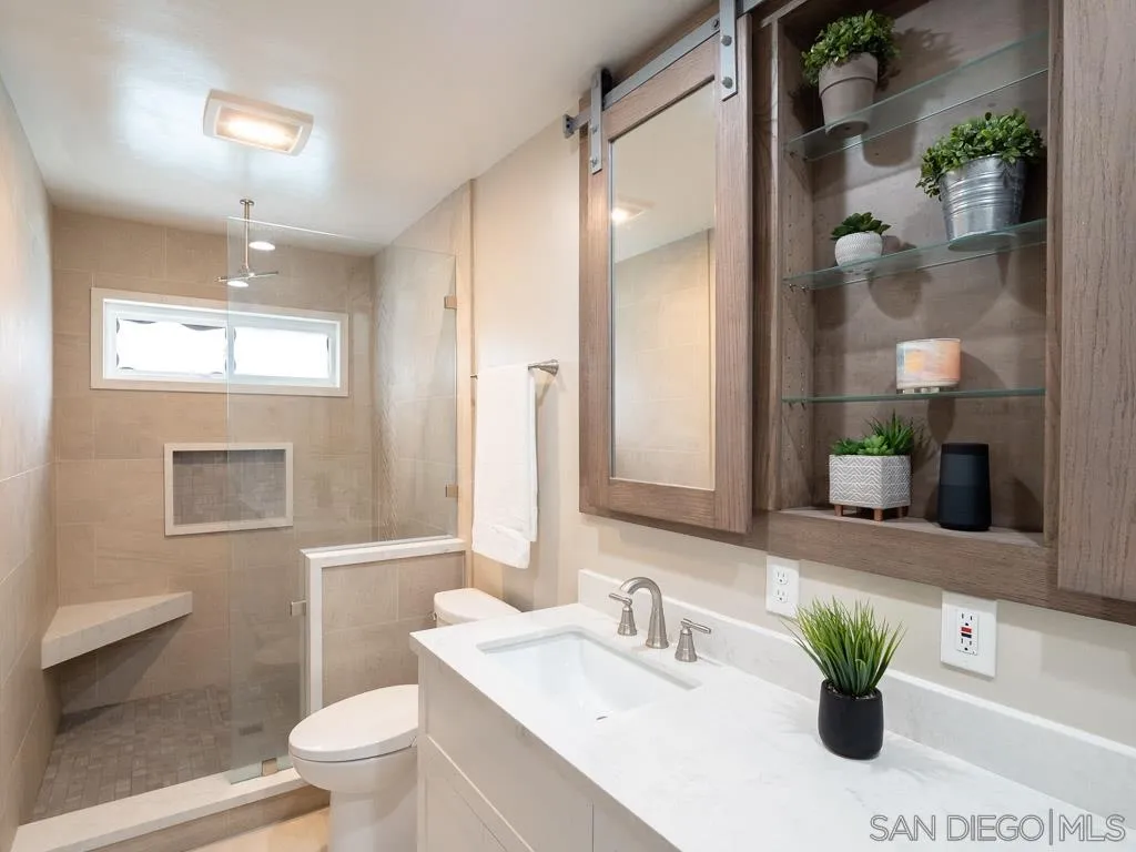 14018 Twin Peaks Road Poway, CA 92064 - Photo 11 of 27 a bathroom with a sink a toilet and a mirror