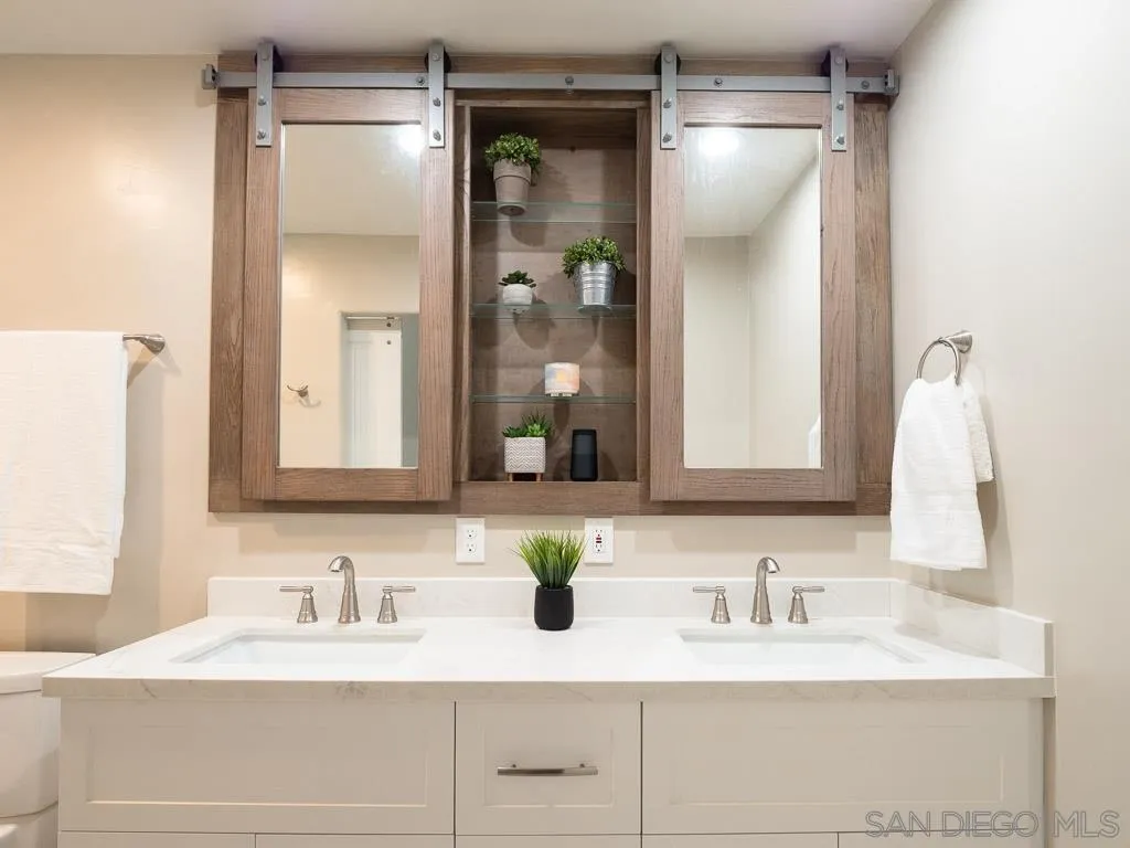 14018 Twin Peaks Road Poway, CA 92064 - Photo 12 of 27 a bathroom with a sink vanity and a mirror