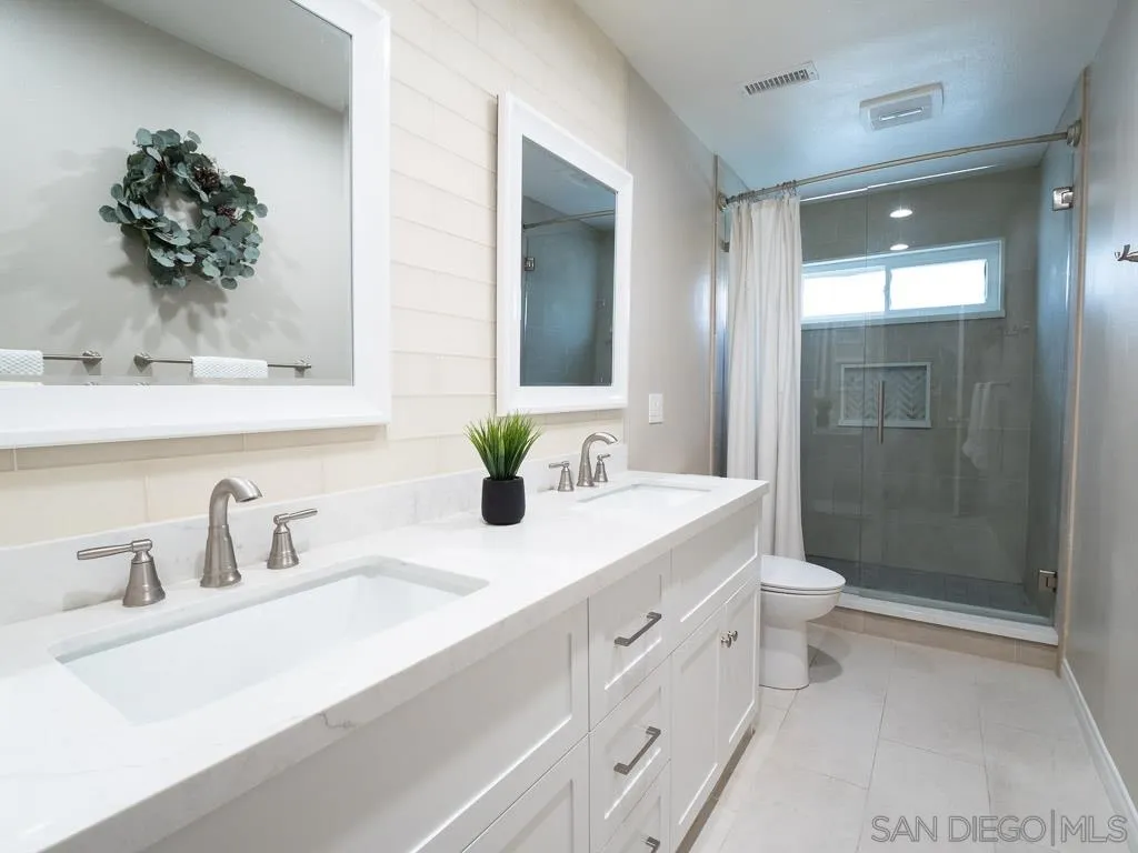 14018 Twin Peaks Road Poway, CA 92064 - Photo 18 of 27 a bathroom with a sink a toilet and shower