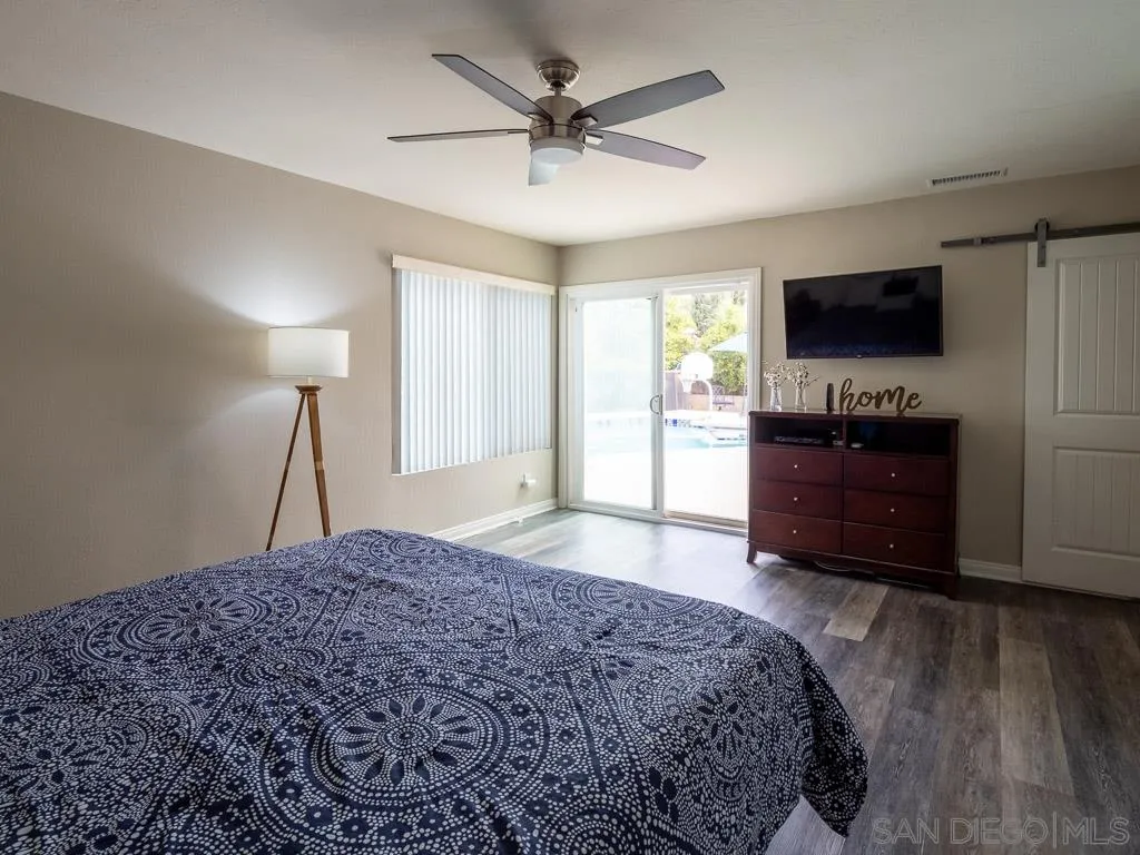14018 Twin Peaks Road Poway, CA 92064 - Photo 9 of 27 a bedroom with a bed and a flat screen tv