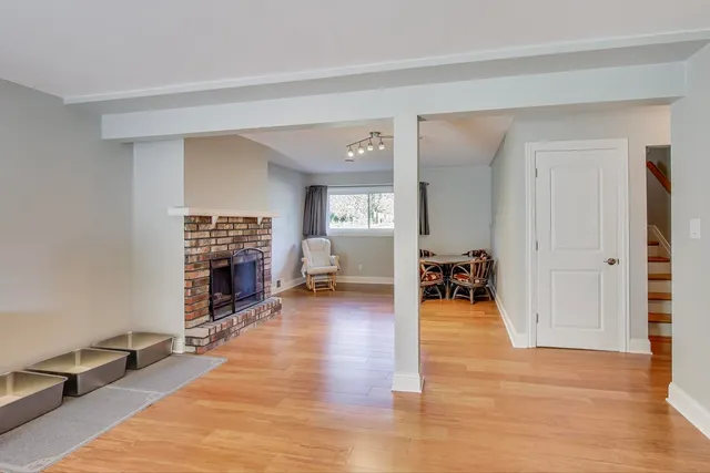 an empty room with furniture and a fireplace