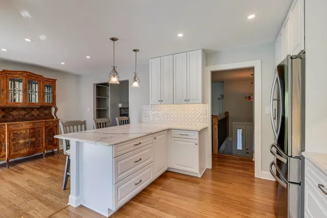 a kitchen with white cabinets and stainless steel appliances