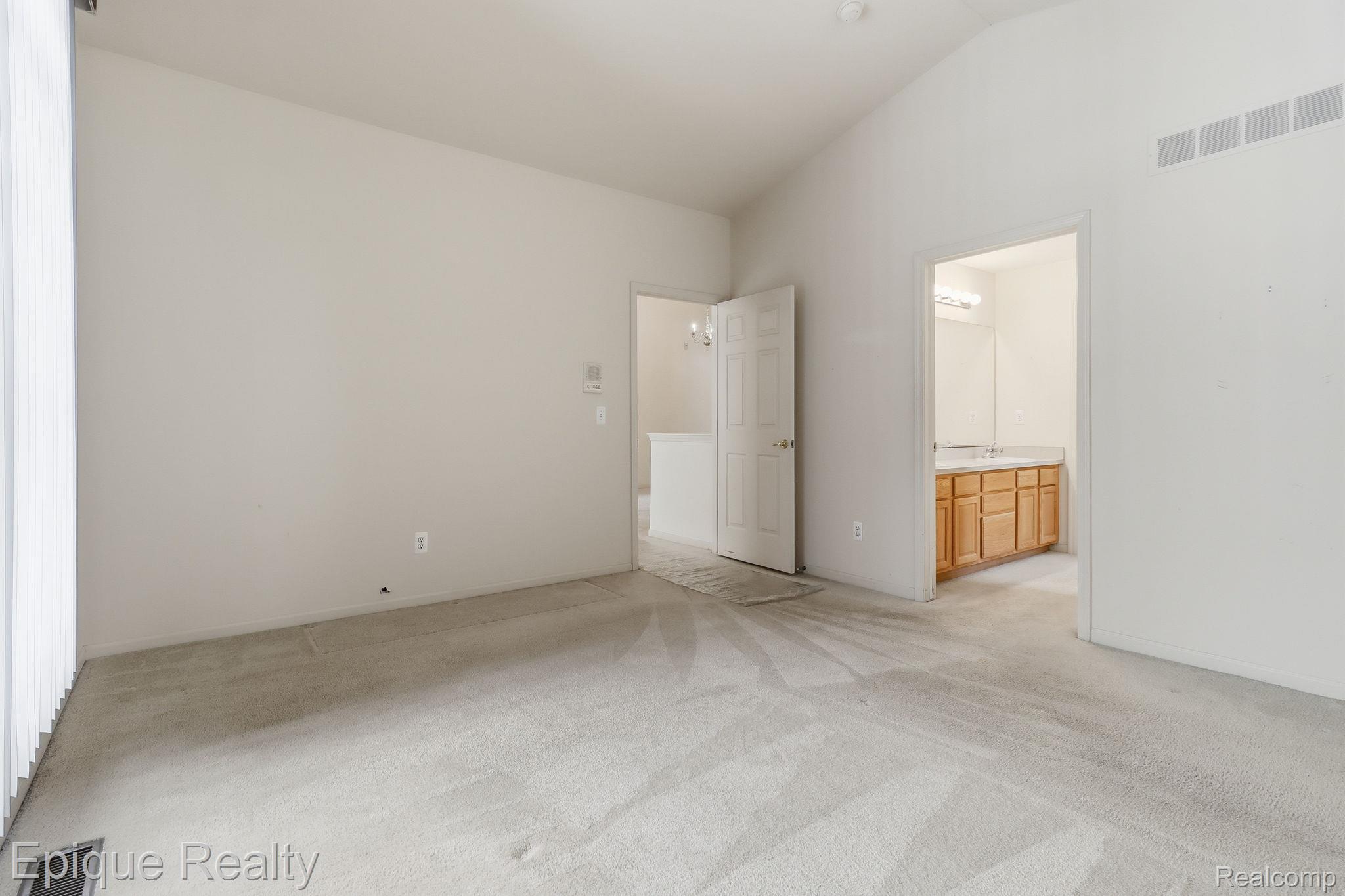321 Cherry Grove Road Canton, MI 48188 - Photo 14 of 22 Unfurnished bedroom with light colored carpet, vaulted ceiling, and ensuite bathroom